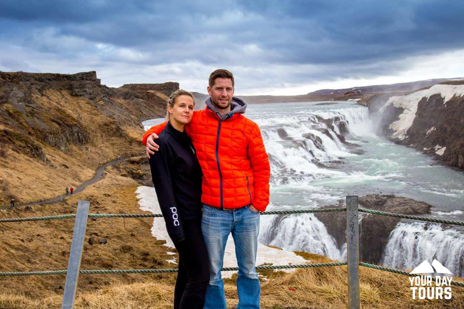 happy couple posing near gullfoss in autumn