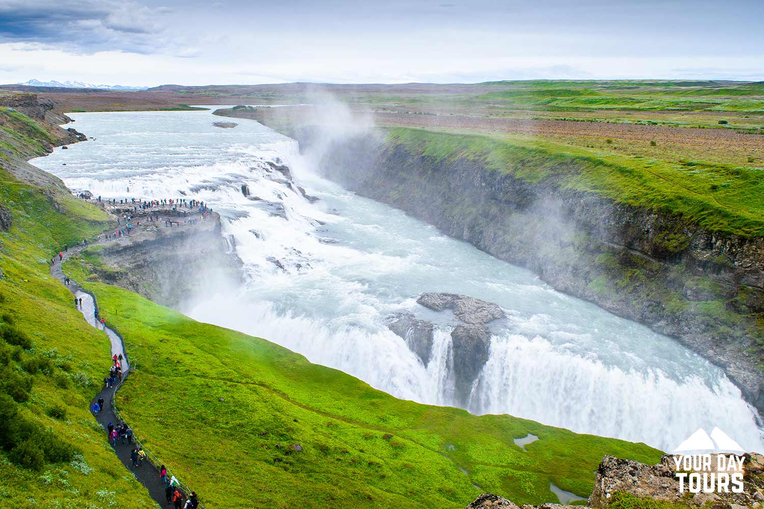 green fields and gullfoss waterfall in iceland 