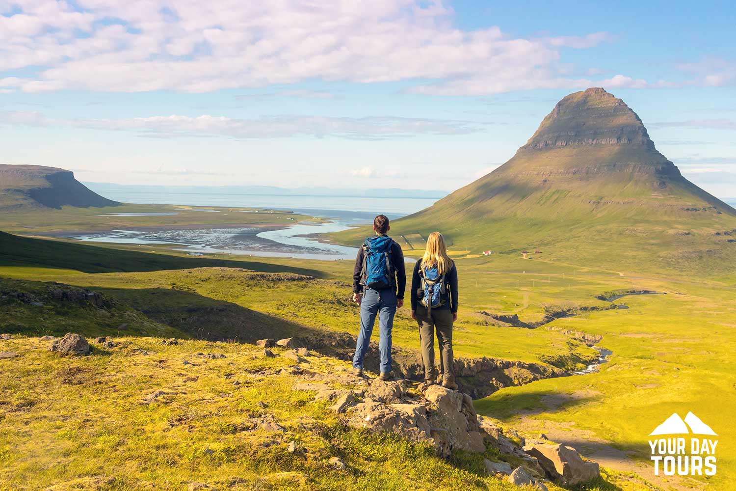 couple hiking near kirkjufell in summer