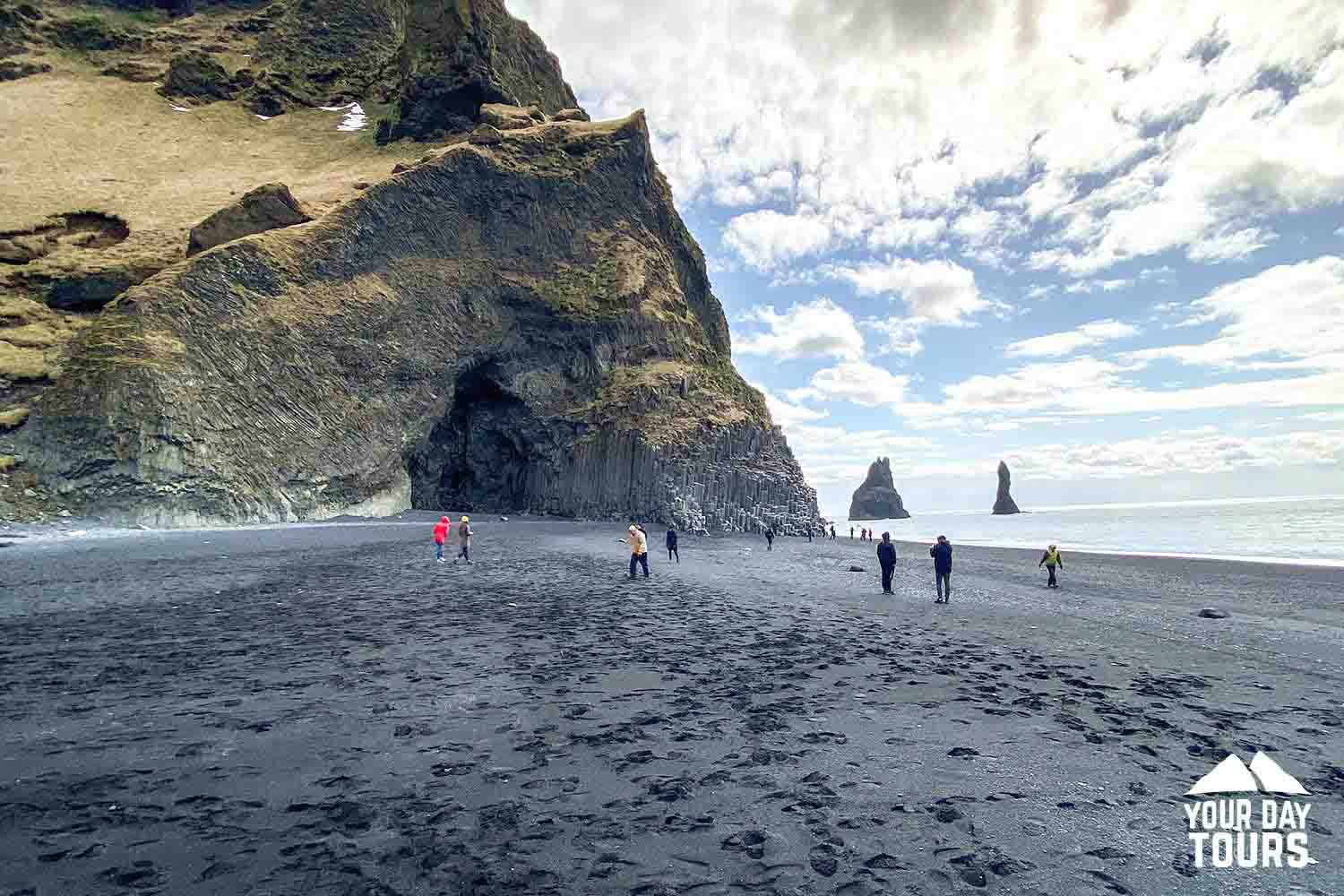people walking at reynisfjara in summer