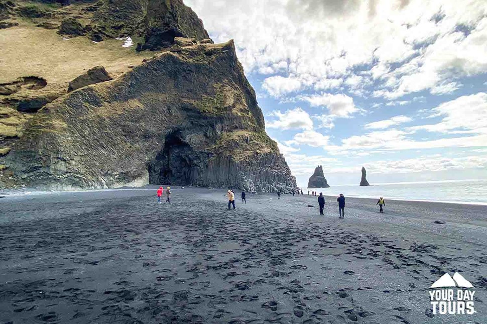 people walking at reynisfjara in summer