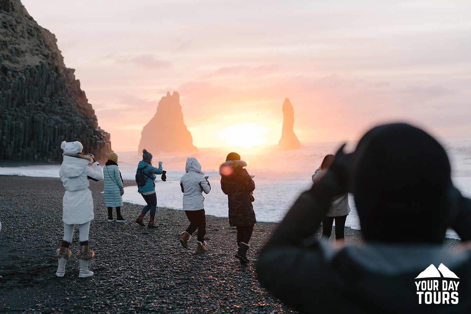 people taking pictures at reynisfjara black sand beach 