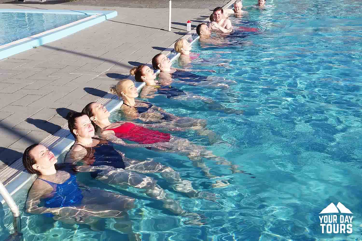 people relaxing in the swimming pool