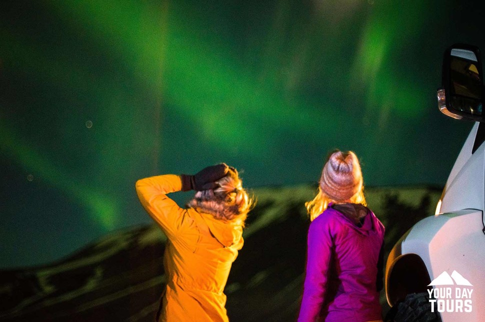 surprised woman looking at the northern lights