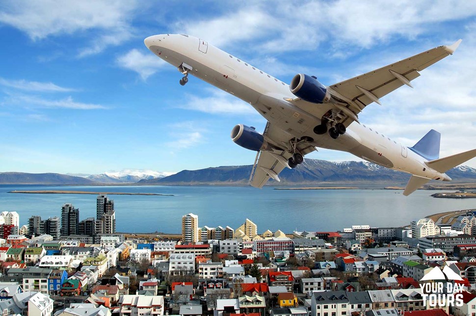 airplane flying above reykjavik city 