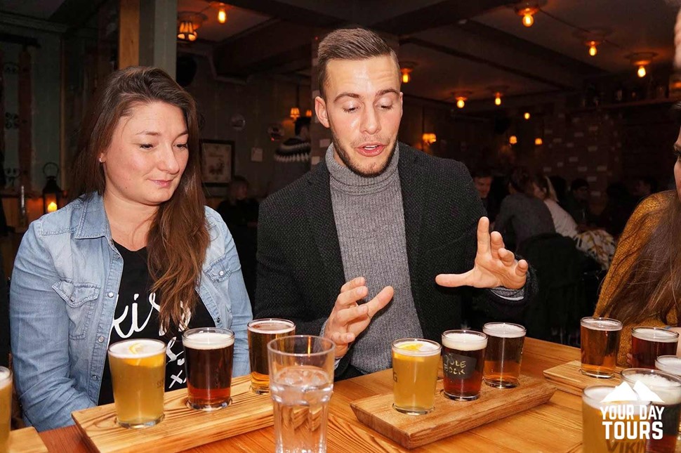 friends drinking beer in a bar 