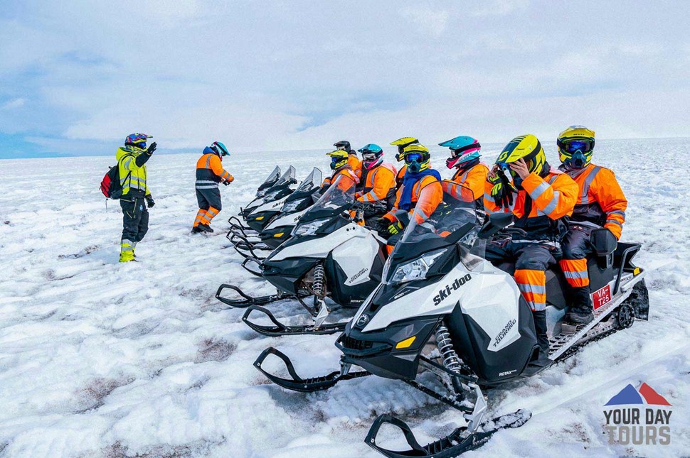 people getting ready to snowmobile 