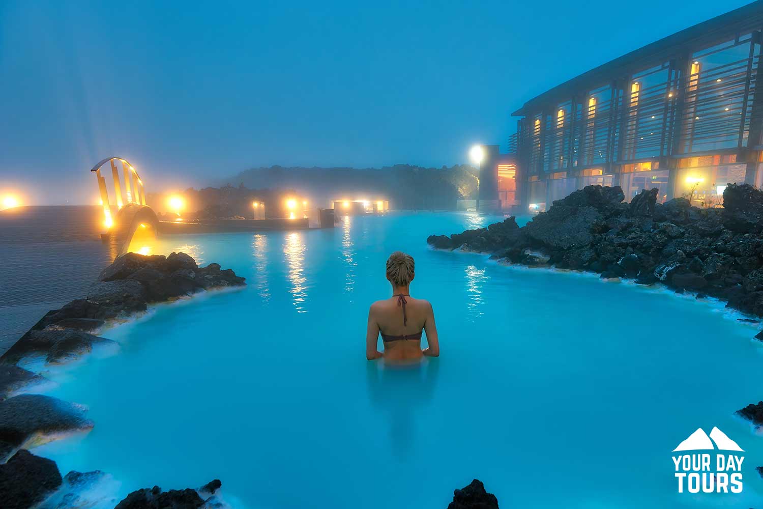 woman bathing at night in blue lagoon 