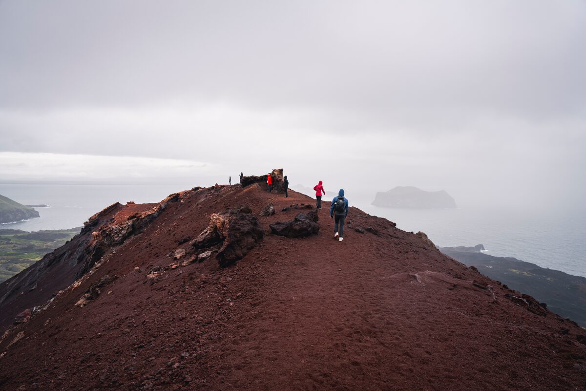People walking on top of Eldfell volcano